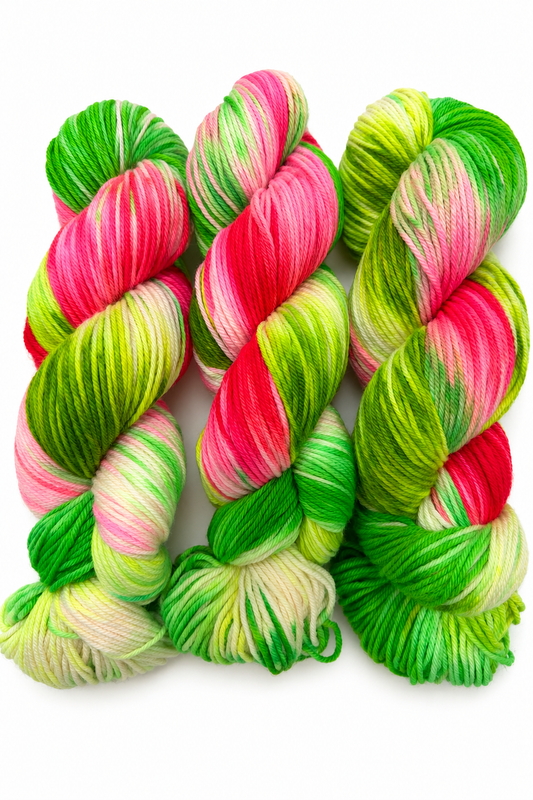 Pasteque hand-dyed DK weight yarn in hot pink, neon orange, and electric yellow