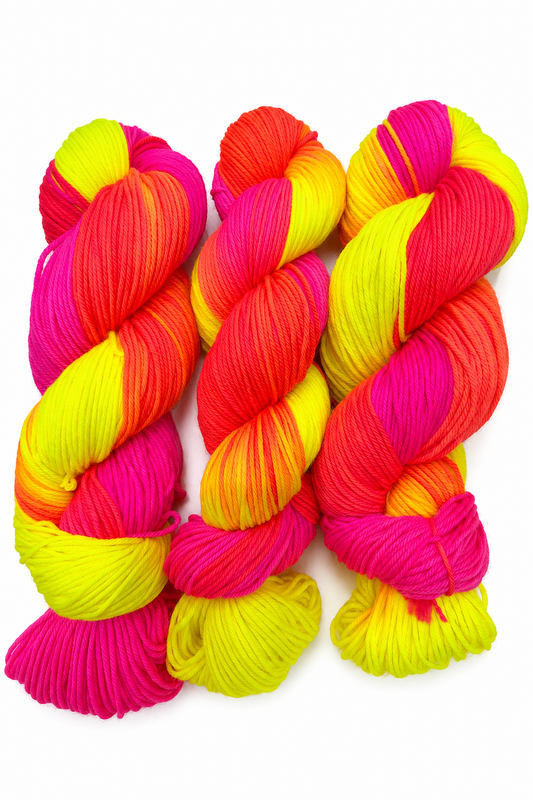 South Beach hand-dyed DK weight yarn in neon pink, teal, white, and yellow